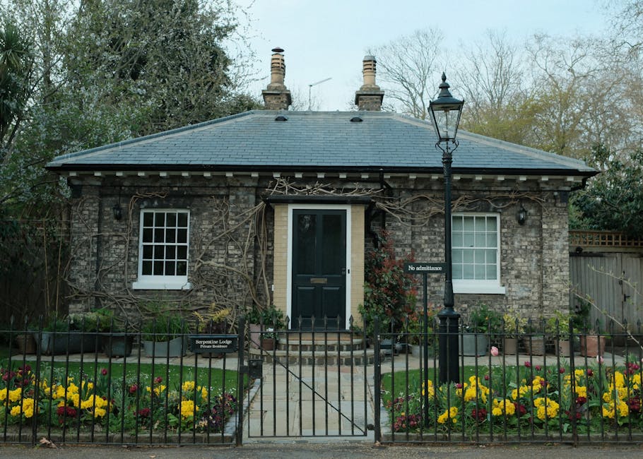 The image shows the entrance to a residential property with a rich, reddish-purple front door set within a white-painted architectural frame featuring a decorative lintel and narrow side panels. The d